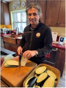 Miguel slices eggplant for Penne alla Norma.