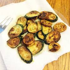 Sauteed zucchini draining on paper towels
